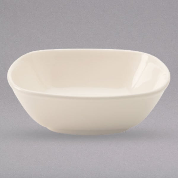 A Homer Laughlin ivory rounded square china bowl on a white background.