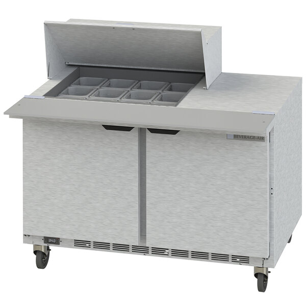 A Beverage-Air refrigerated sandwich prep table with two doors open on a counter.