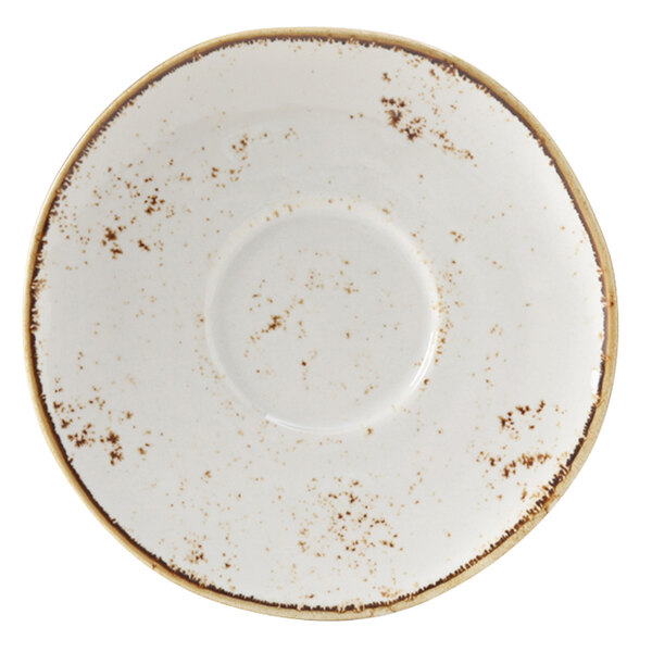A white Tuxton saucer with brown speckles on the edges.