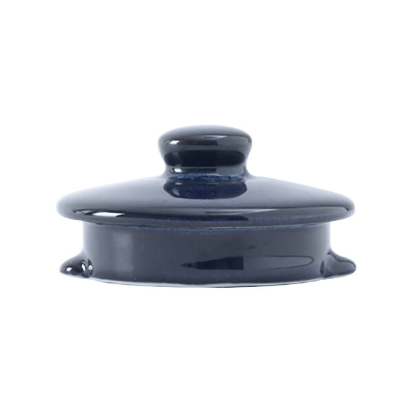 A blue ceramic lid with a black knob on a round lid.