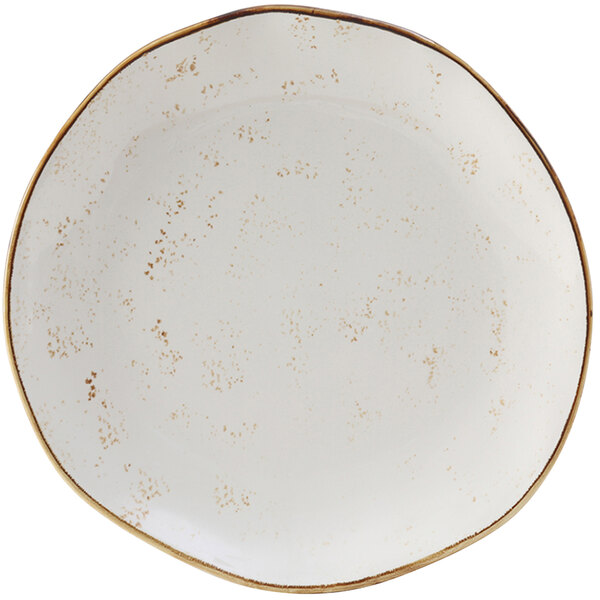 A white plate with brown speckled edges.