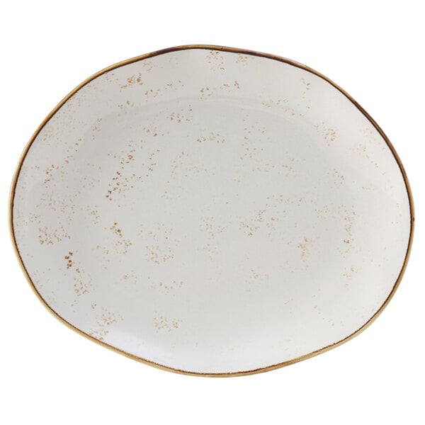 A white Tuxton china platter with brown specks and a gold rim.