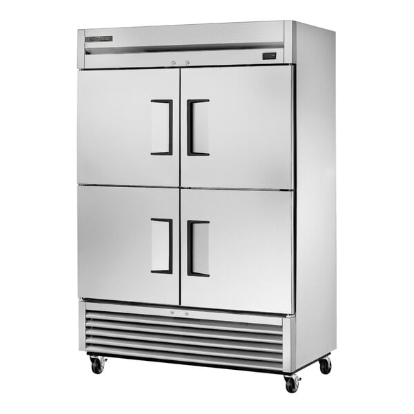 A silver True 2 section reach-in freezer with half doors.