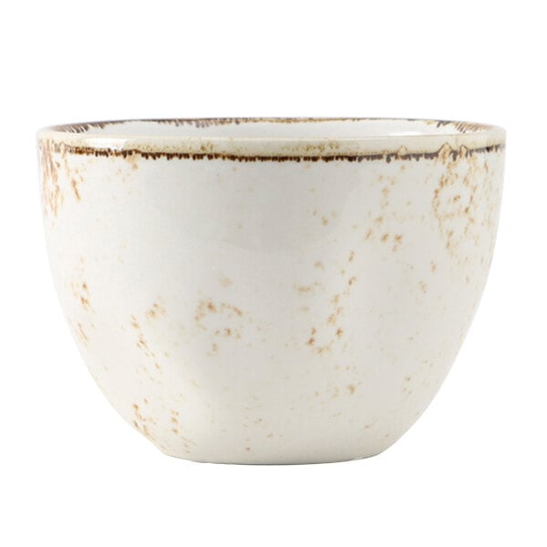 A white bouillon cup with brown speckles on it.