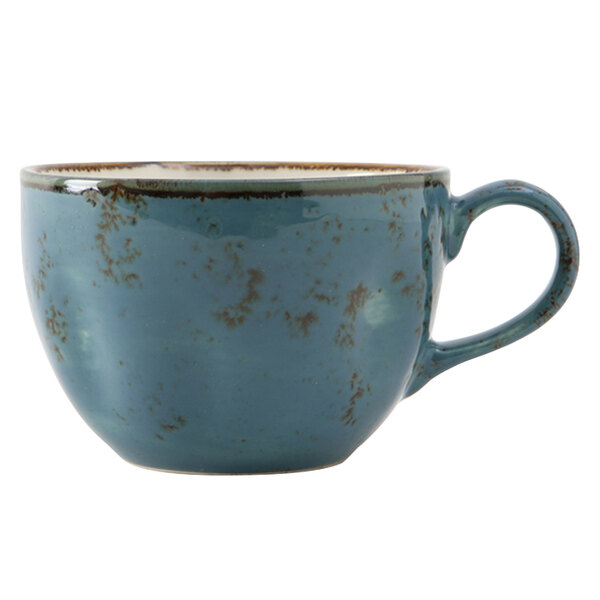 A close-up of a TuxTrendz Artisan Geode Azure blue coffee cup with a brown rim and handle.