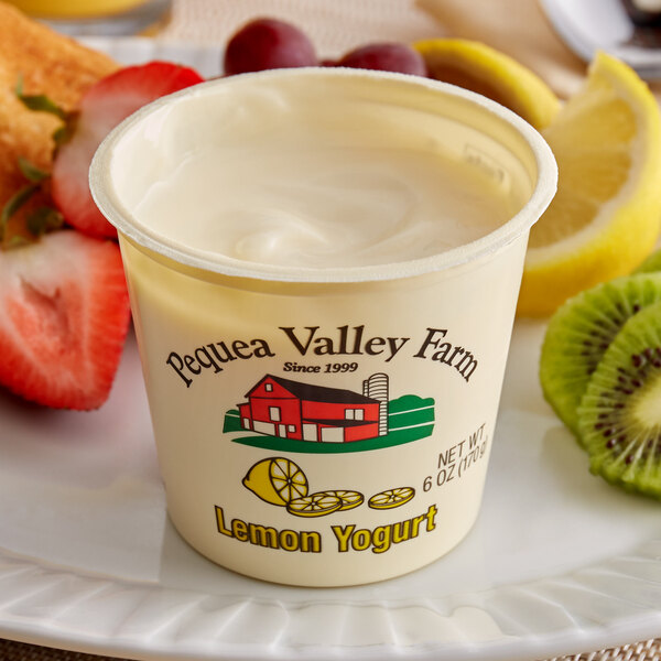 A close-up of a Pequea Valley Farm lemon yogurt cup with a spoon in it.