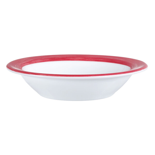 An Arcoroc white opal glass bowl with a red rim.