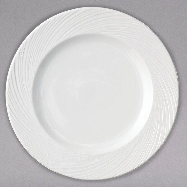 A white Arcoroc porcelain banquet plate with swirls on it.