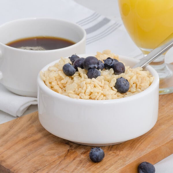 A bowl of Crisp Rice Cereal with blueberries and a spoon.