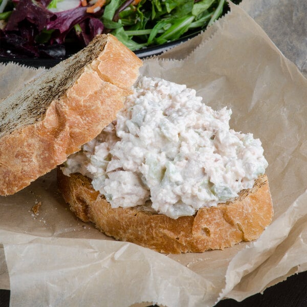 A bowl of Spring Glen Fresh Foods Tuna Salad on a sandwich.