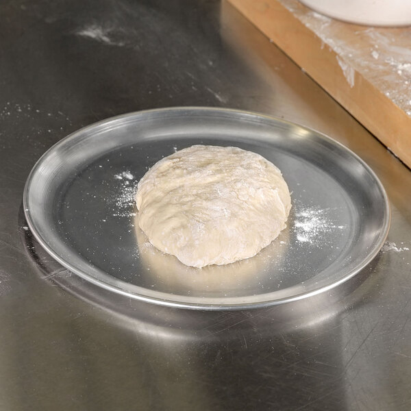 A ball of dough on an American Metalcraft aluminum pizza pan.