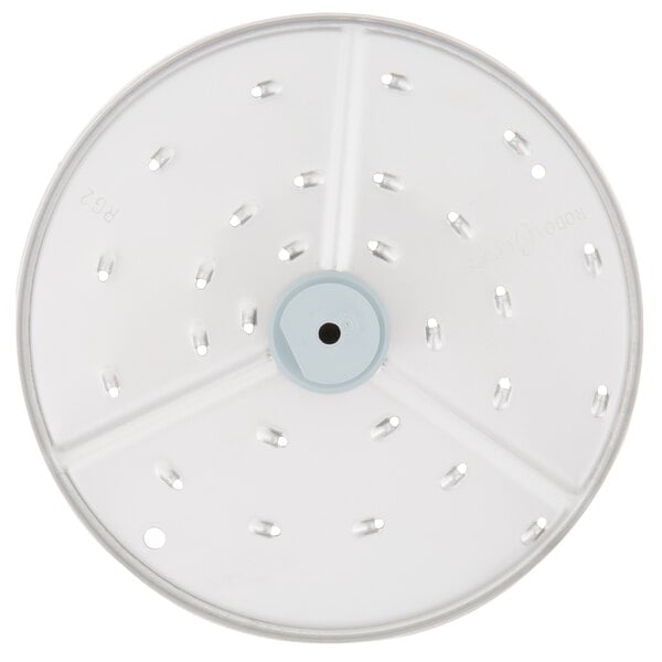 A white circular Robot Coupe grating / shredding disc with holes in it.