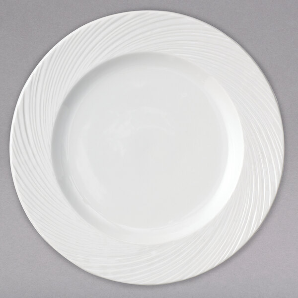 A white porcelain brunch plate with a wavy design on it.