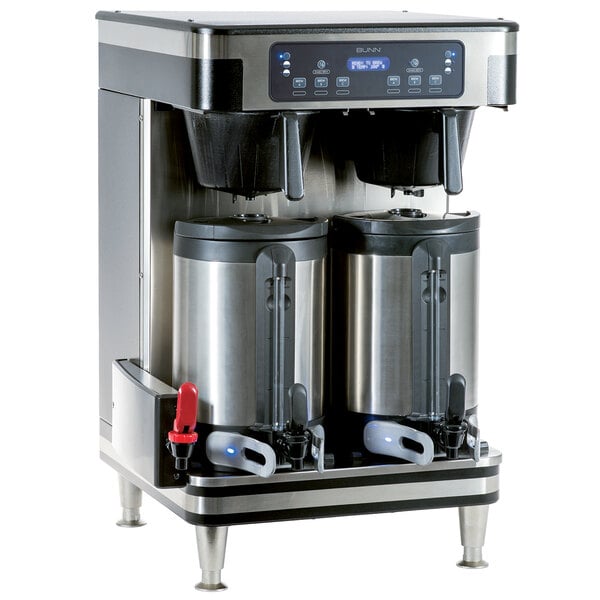 A Bunn commercial coffee maker with two coffee cans on top.