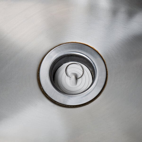 A silver sink drain with a Regency rubber sink stopper in it.
