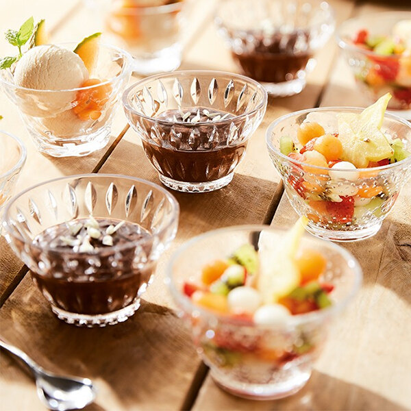 A table with several Arcoroc glass dessert bowls with fruit and chocolate desserts.