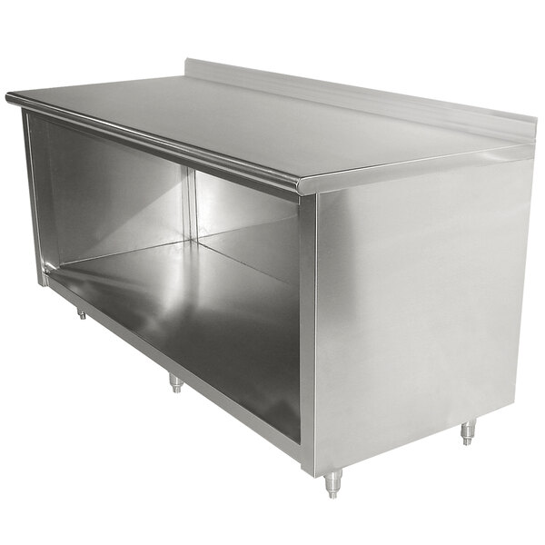 A stainless steel Advance Tabco work table with an enclosed cabinet base and a shelf.