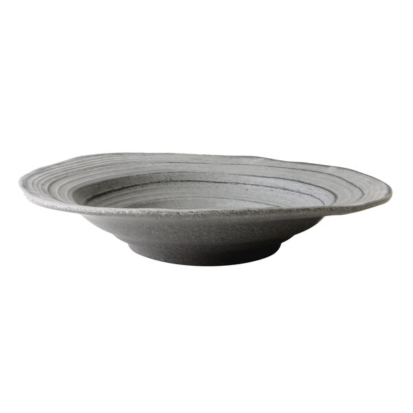A close up of a grey Elite Global Solutions irregular round serving bowl with a curved edge and a granite stone design.