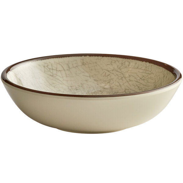 A white Elite Global Solutions small round melamine bowl with a brown rim.