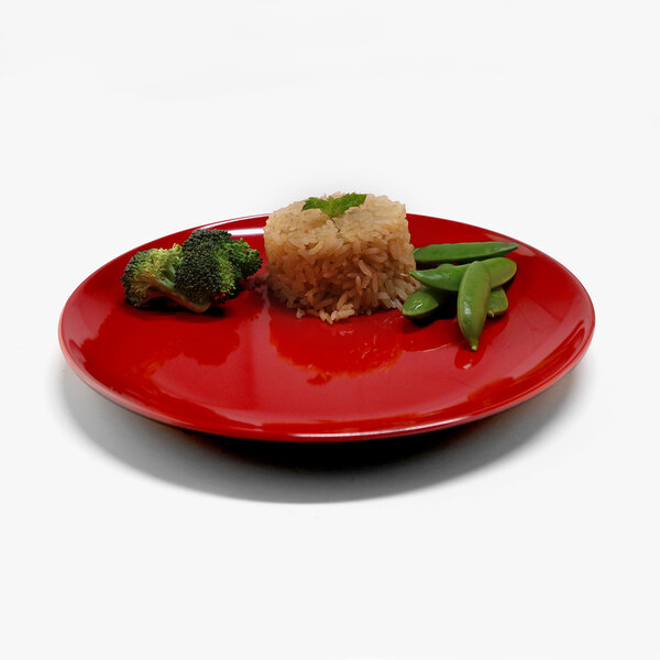 A close up of a red Elite Global Solutions Karma melamine plate with rice, broccoli, and a leaf.