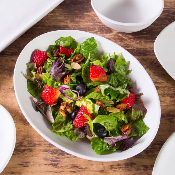 A salad with strawberries and nuts on a white Elite Global Solutions Tenaya melamine plate.