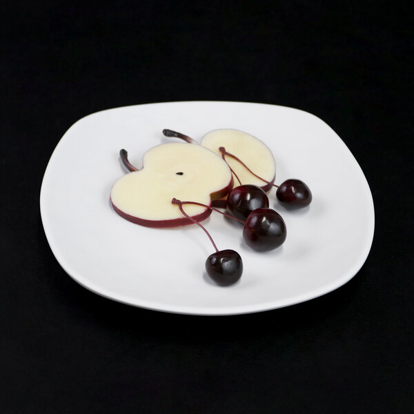 An Elite Global Solutions off white square melamine plate with fruit on it.