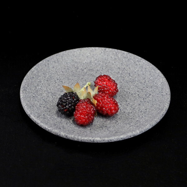 A Elite Global Solutions granite stone melamine plate with berries on it.