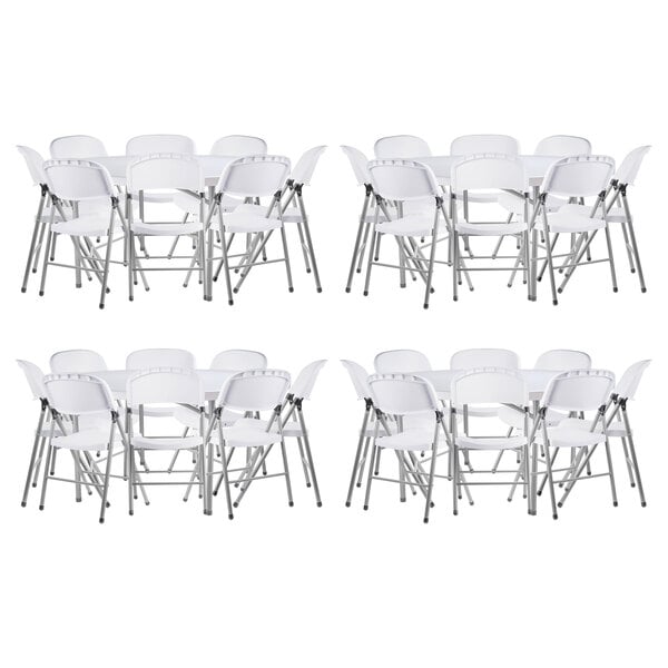 A group of Lancaster Table & Seating white folding chairs stacked.