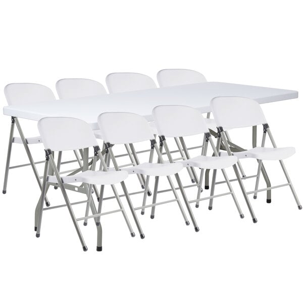 A Lancaster Table & Seating white folding table with 8 white folding chairs.