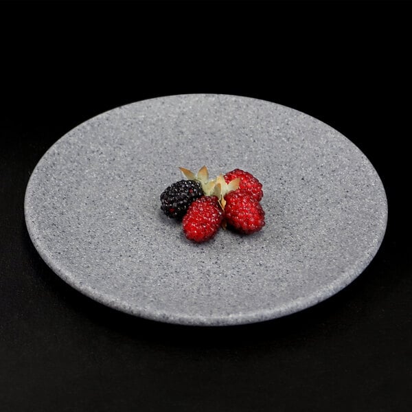 An Elite Global Solutions granite stone melamine plate with berries on it.