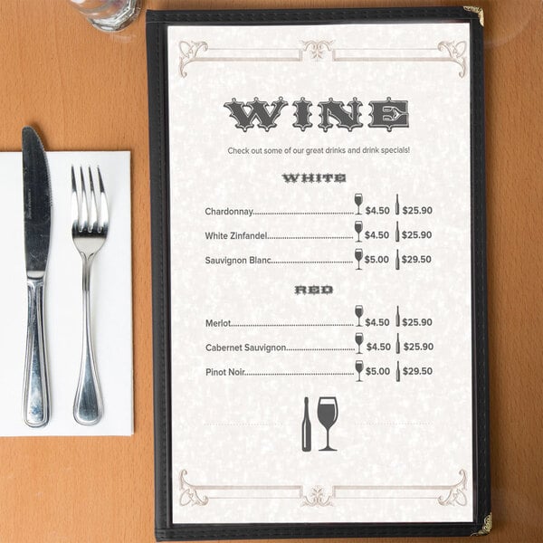 A tan swirl border menu on a table with a knife and fork.