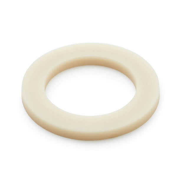 A close-up of a white plastic washer with a hole in the center.
