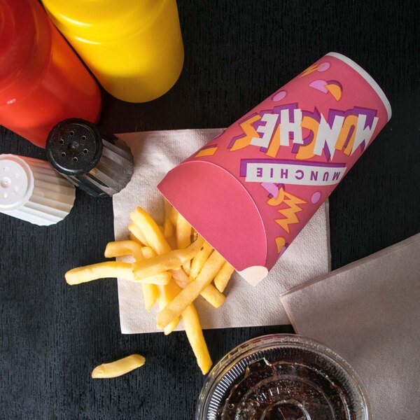 A red and yellow Solo paper container filled with French fries on a table.