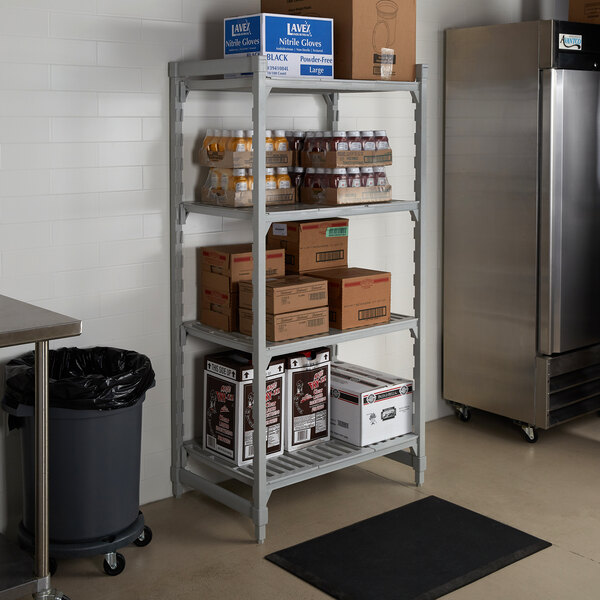 A Cambro Camshelving Premium unit with vented shelves holding boxes and bottles.