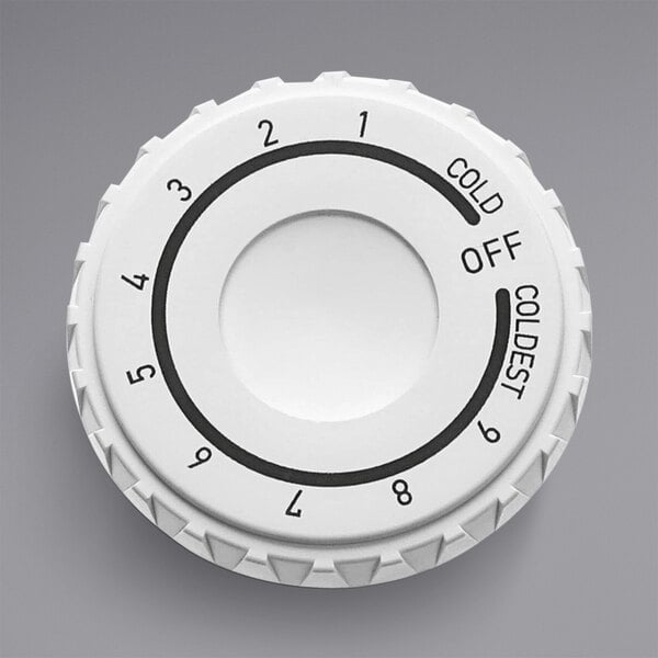 A white Kelvinator control knob with black numbers.