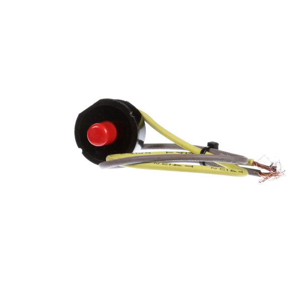 A round black and yellow thermal protection device with a red button.