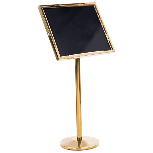 A black sign board with a gold pedestal.