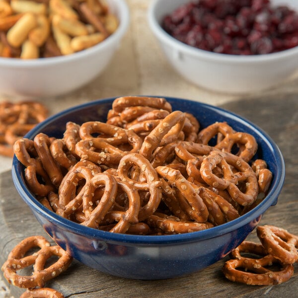 A Carlisle Dallas Ware cafe blue nappie bowl filled with pretzels on a table.