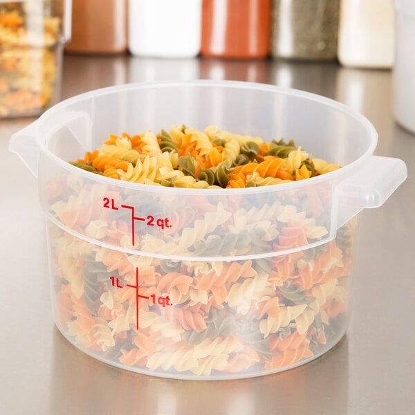 A translucent plastic Cambro food storage container filled with pasta.