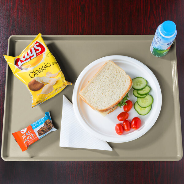 A Cambro desert rain fiberglass dietary tray with a sandwich, vegetables, and a drink on it.