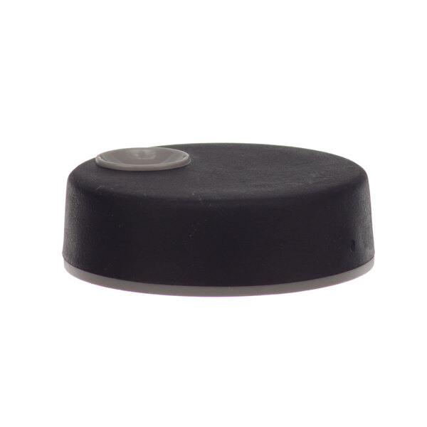 A black and white plastic knob with a small hole on top.