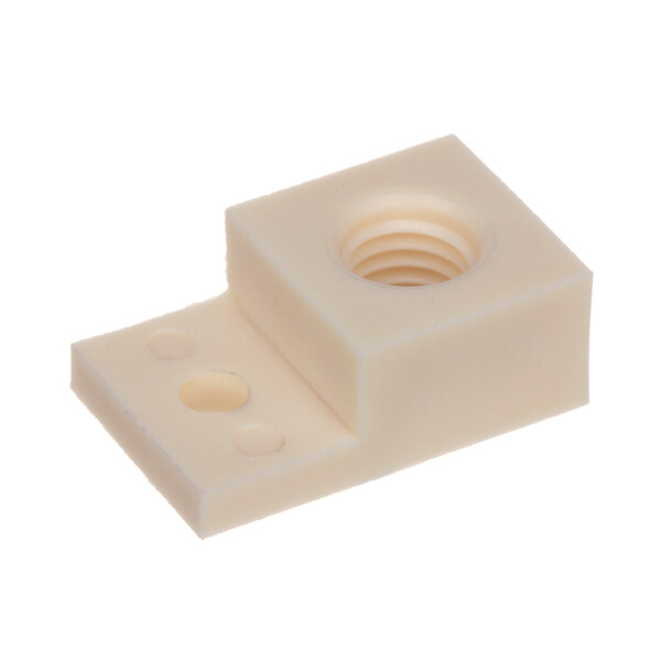 A white plastic block with a circular hole and a nut in it.