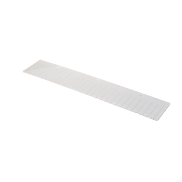 A white rectangular plastic object with 36 slots.