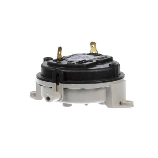 A small round black and white Broaster pressure diff switch.