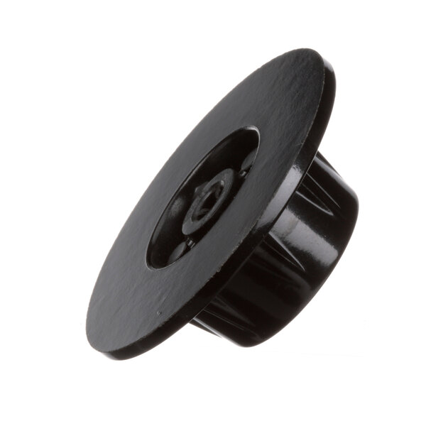 A close-up of a black plastic knob with a nut.