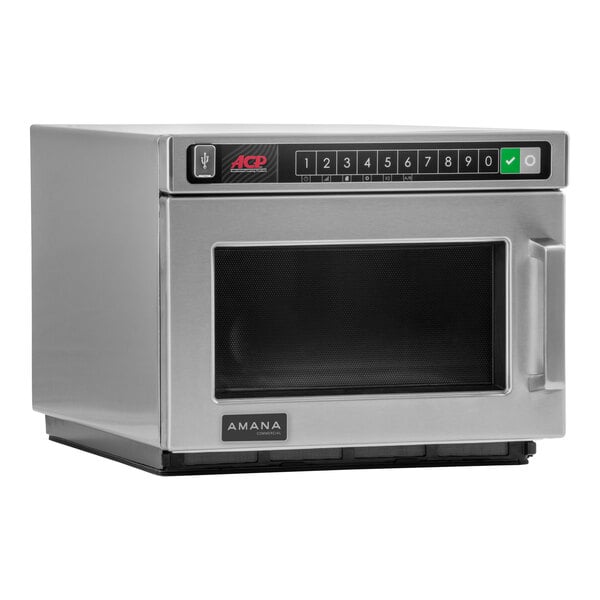 An Amana stainless steel commercial microwave oven with a black door.