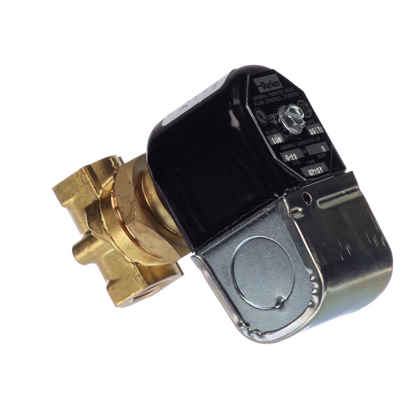 A close-up of a brass Jackson solenoid valve with black and silver metal parts.