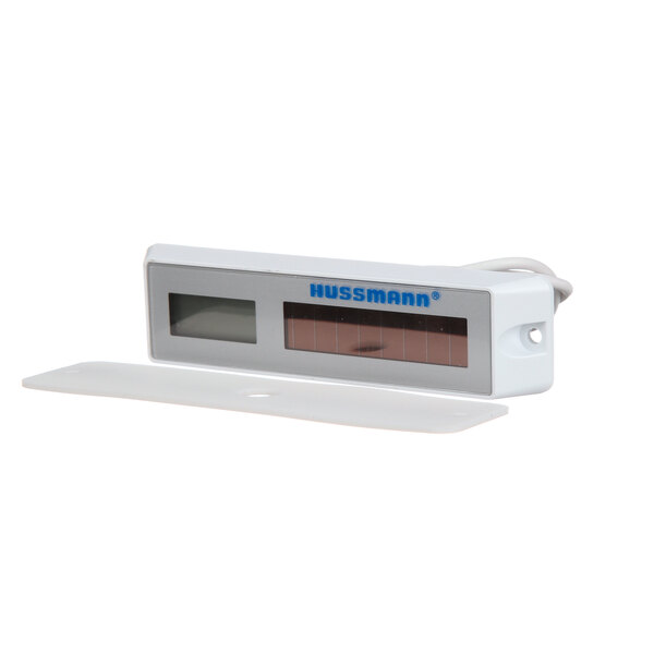 A white rectangular Hussmann thermometer with a screen.