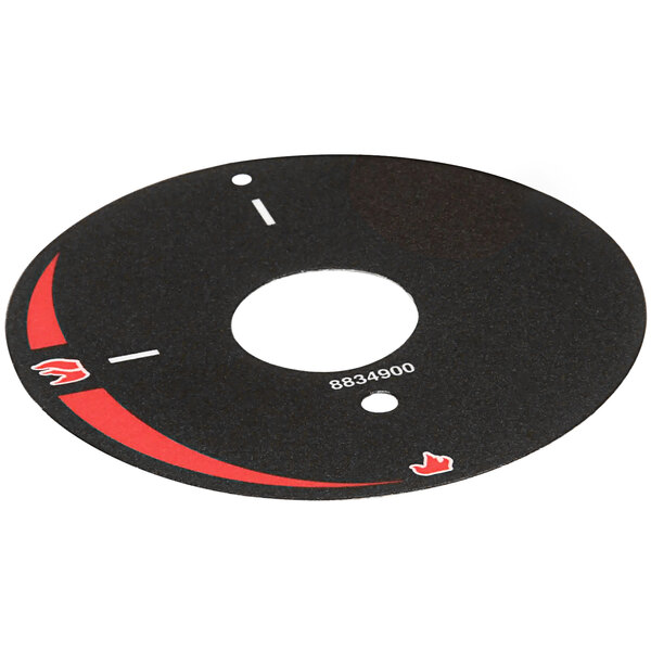 A circular black and red decal with a red circle in the middle.