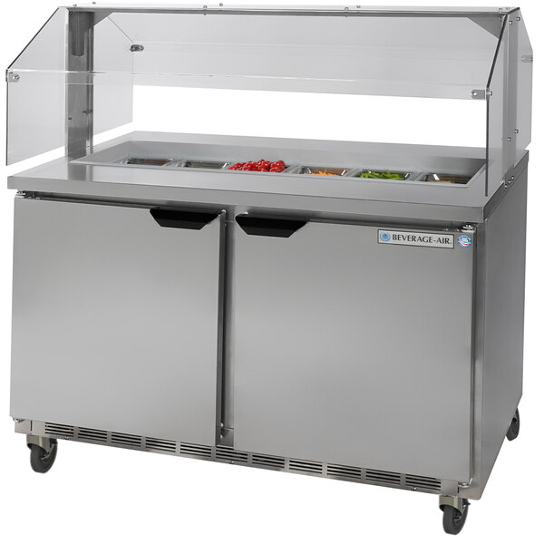 A Beverage-Air stainless steel refrigerated sandwich prep table with two compartments and a sneeze guard.